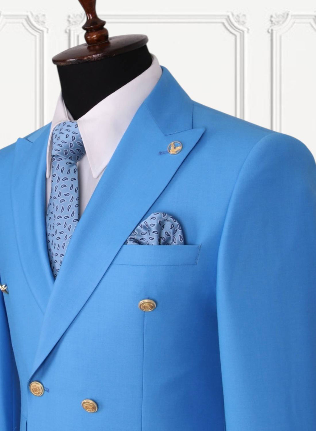 Bright blue GEEMAN suit lapel and gold button detail